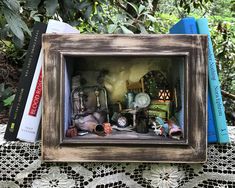 there is a miniature photo frame with many things in it