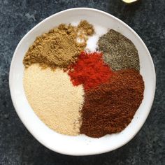 a white bowl filled with different types of spices