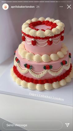 a three tiered cake with red and white icing