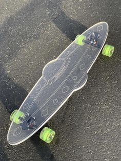 a skateboard with green wheels sitting on the ground