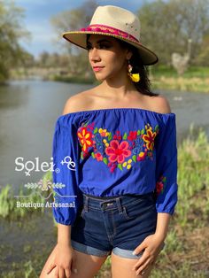 This Beautiful Off the Shoulder Crop Top is the perfect Top for a fun day out. It's made out of cotton, has an elastic waist and has hand embroidered florals. This blouse is hand embroidered and the embroidered colors vary on each blouse making each blouse one of a kind. More colors available here: https://www.etsy.com/es/listing/855531148/crop-top-manga-larga-blusa-artesanal?ref=listings_manager_grid Purchase the Artisanal Mexican earrings modeled here: https://www.etsy.com/es/listing/802949597 Multicolor Embroidered Summer Vacation Top, Summer Vacation Multicolor Embroidered Tops, Summer Embroidered Cotton Top For Spring, Blue Cotton Embroidered Summer Top, Summer Festival Cotton Blouse, Embroidered Cotton Tops For Summer, Spring Festival Cotton Blouse, Summer Cotton Top With Floral Embroidery, Summer Embroidered Tops For Festival