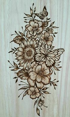 a drawing of flowers and butterflies on a wooden background