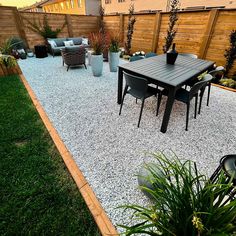 an outdoor patio area with gravel and plants