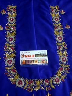 an embroidered blue cloth with gold and red flowers on the border, along with a sticker that says mailin