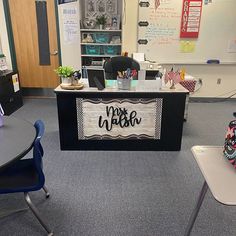 a classroom with desks, chairs and a sign that says your teacher on it