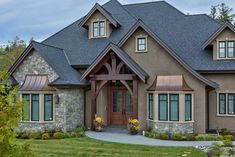 a large house with stone and wood accents