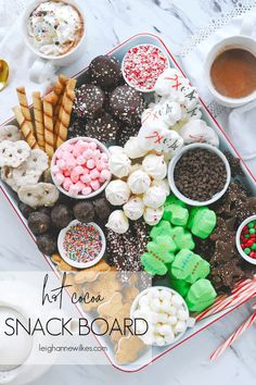 a tray filled with lots of different types of snacks and desserts on top of a table