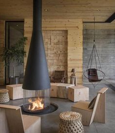 a living room filled with lots of furniture and a fire place in the middle of it