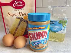 ingredients to make cake sitting on a counter next to an egg carton and bag