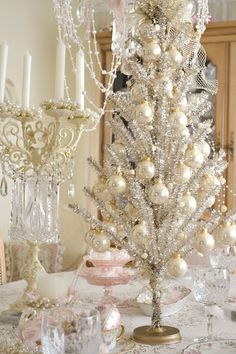 a white christmas tree sitting on top of a table