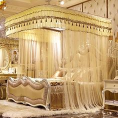 a bedroom with a canopy bed and chandelier on the ceiling is decorated in gold