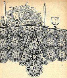 an old lace tablecloth with candles and flowers on it, from the early 1900's