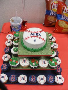 a baseball themed birthday cake and cupcakes on a table