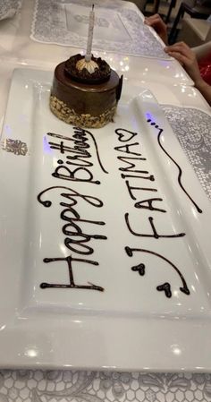 a birthday cake sitting on top of a white plate with the words happy birthday written on it