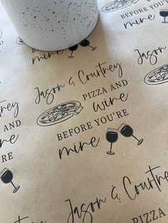 a table topped with pizza and wine next to a cup