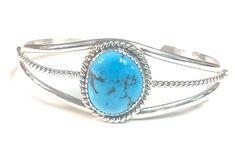 Native American Navajo handmade Sterling Silver Turquoise cuff bracelet * Native American handmade * Navajo Tribe * Sterling Silver * Stone: Kingman Turquoise * Width: 3/4 in * Length: 6 in incl gap * Slightly adjustable * Signed For more information regarding this piece or any questions you may have please feel free to message us. Thank you! Western Style Blue Cuff Bracelet Gift, Handmade Southwestern Turquoise Cuff Bracelet, Handmade Turquoise Western Cuff Bracelet, Handmade Western Turquoise Bracelet, Handmade Western Turquoise Bracelets, Handmade Western Style Turquoise Bracelet, Southwestern Blue Oval Bracelets, Navajo Tribe, Turquoise Bracelet Cuff