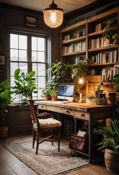 a desk with a laptop on top of it in front of a book shelf filled with books