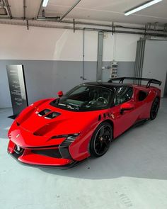 a red sports car parked in a garage