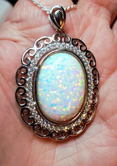 Huge White Opal Necklace, 18x25mm Lab Created Synthetic Opal With Rainbow Fire, Lots Of Pink, See Video! 925 Sterling Silver Curls And Cubic Zirconia Halo Pendant, Rhodium Plated, 20" Sterling Chain. Gift Box Included.  *This Beauty Is Really Big, For Lovers Of Bold Jewelry We Also Have In Blue White Oval Pendant With Polished Finish, White Gold Oval Pendant With Cabochon, White Gold Jewelry With Large Oval Pendant, White Oval Necklace With Polished Finish, Anniversary White Gold Cabochon Necklace, Oval Large Pendant Jewelry For Anniversary, White Oval Sterling Silver Jewelry, White Hallmarked Oval Pendant Jewelry, White Gold Sterling Silver Cabochon Necklace