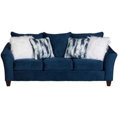 a blue couch with two pillows on the back and one pillow that has white fur