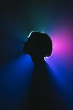 a woman's head is shown with the light coming from behind it in front of her