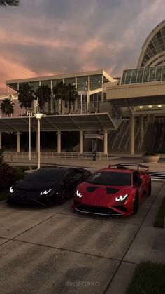 two exotic cars parked in front of a large building at sunset or sunrise with palm trees