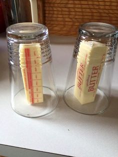 two salt and pepper shakers sitting on top of a counter