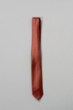 an orange neck tie on a gray background