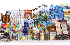 a large amount of bottles are stacked on top of each other in front of a white background