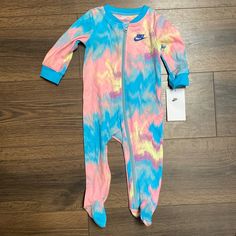 Nwt. Baby Onesie With Zipper. Blue, Pink, Yellow Pattern With Nike Symbol On Feet. Size 9m. 18.5-22lbs. 26.5-29in. Nike Onesie, Nike Symbol, Yellow Pattern, Kids Nike, Pink Yellow, Pink Blue, Baby Onesies, Kids Shop, One Piece