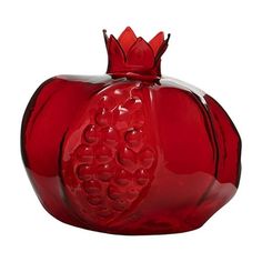 a red glass vase with a heart shaped decoration on the top and bottom, sitting in front of a white background