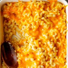 a casserole dish with macaroni, cheese and a spoon in it