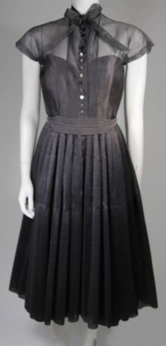 This Robert Rodriguez of Madrid dress is composed of a grey silk organza. There is a center front neck tie with mother of pearl style buttons. The skirt features a full tightly pleated design. Made in Spain. Available at 1stDibs. 1960s Dresses, Robert Rodriguez, Gray Silk, 1950s Dress, Silk Organza, 1950s Fashion, Mother Of Pearl, Neck Tie, Style Me