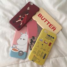 three cell phones are sitting next to each other on a white sheet with the words butter printed on them