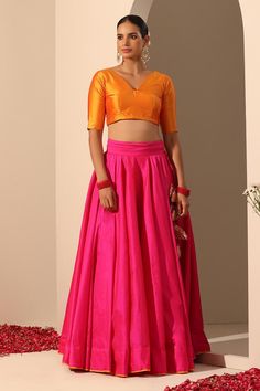 Hot pink solid lehenga crafted in tafetta silk with statement tassels. Paired with a blouse and gota lace bordered dupatta.
Components: 3
Pattern: Embroidered
Type Of Work: Gota lace
Neckline: V Neck
Sleeve Type: Elbow
Fabric: Lehenga and Blouse: Tafetta Silk, Dupatta: Soft Net
Color: Pink
Other Details: 
Length:
Lehenga: 40 inches
Dupatta: 2.5 mtrs
Dupatta width: 44 inches
Occasion: Mehendi and Haldi - Aza Fashions Navratri Sharara With Latkans, Festival Choli With Latkans, Pink Tassel Sets For Navratri, Festive Fitted Choli With Tassels, Fitted Wedding Sets With Tassels, Wedding Sets With Tassels And Fitted Design, Diwali Lehenga With Tassels, Bollywood Choli With Tassels, Tasseled Lehenga For Diwali