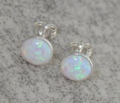 Shop Opal Stud Earrings, White Opal Earrings Sterling Silver , 8mm Opal, Bridesmaid Gift, Bridal Opal Jewelry, Gift For Her I made these white opal earrings with: - Gorgeous multicolored lab created round opal cabochons-8 mm - Solid 925 sterling silver bezels with a post You'll get sterling silver stoppers and silicone backs. Created opals are actually preferred to natural opals for many jewelry items. Natural opal is not particularly well-suited to being used in many jewelry applications since Silver Opal Jewelry, Wedding Cyprus, White Opal Earrings, Opal Stud Earrings, Opal Earrings Stud, Opal Studs, Earrings White, Opal Earrings, Natural Opal