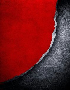 a torn red piece of paper on a black background