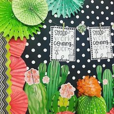 a bulletin board decorated with paper flowers and cactus