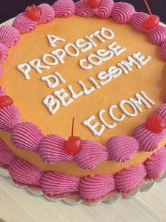 a cake decorated with pink icing and cherries is on a plate that says, proposto di coste bellissme ecocom