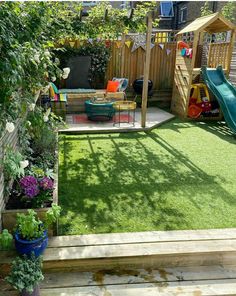 an outdoor play area in the backyard with grass and wooden steps leading up to it