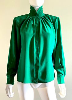 "Gorgeous vintage C1980s sumptuous, butter soft heavy silk long sleeved forest green blouse by Levante, featuring a nehru collar, front and back top pleats, and a front button closure under a hidden button placket. Approximate Measurements:        Chest, Waist, Hips: Up to 48\"; Length: 23\"        Labeled a size 6 Fabric:  100% silk Condition: Excellent, likely unworn, vintage condition." Green Long Sleeve Formal Blouse, Green Long Sleeve Blouse For Formal Occasions, Elegant Long Sleeve Green Blouse, Green Long Sleeve Top For Evening, Formal Green Blouse For Fall, Vintage Green Silk Top, Vintage Green Formal Tops, Green Silk Tops For Fall, Nehru Collar Blouse