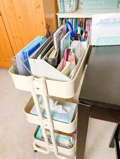 an office desk with several bins on the top and one drawer full of files