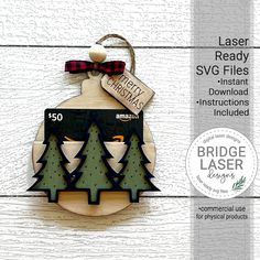 a wooden ornament with trees and a tag on it that says laser ready sv files instant instructions included