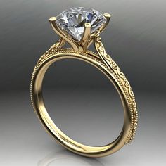 a gold engagement ring with an intricate design on the band and a round diamond center stone