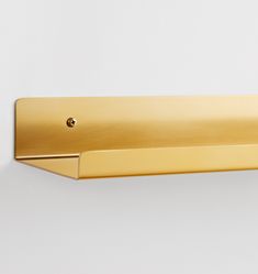 a gold door handle on a white wall