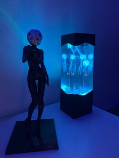 a plastic doll standing next to an illuminated display case