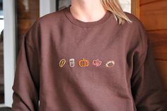 Hand embroidered fall themed sweatshirt. Perfect for pumpkin spice latte sippin' and football watchin' this fall! Brown Fall Sweatshirt With Embroidered Logo, Brown Sweatshirt With Embroidered Logo For Fall, Brown Sweatshirt For College In Fall, Fall Sweatshirt With Embroidered Graphics, Fall Long Sleeve Sweatshirt With Custom Embroidery, Hand Embroidered Sweatshirt, Embroidered Sweatshirt, Pumpkin Spice Latte, Embroidered Sweatshirts