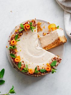 a piece of cake on a plate with orange flowers and leaves around it next to a fork