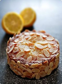 a cake with almonds and lemon slices on it