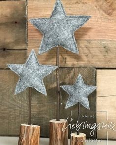 three silver glitter stars on top of wooden sticks